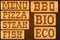 Nameplate of wood with words Menu Grill Steak