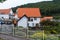 Namhae,South Korea-November 2020: Germany style red roof and white wall house building with mountain view with white fence at