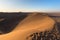 Namib desert, sand dunes footprints, scenic ridge at sunset, Sossusvlei, Swakopmund, Namib Naukluft National Park, travel destinat