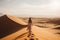 In Namib Desert, a woman walks barefoot, gazing at the vast dunes