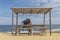 NAMIBE/ANGOLA 02NOV2018 - Couple sitting on wooden porch overlooking the sea