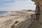 NAMIBE/ANGOLA 02NOV2018-Young girl walks on a canyon path by the wild Namibe beach. Angola. Africa