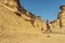 NAMIBE/ANGOLA 03NOV2018 - Young girl jumping in the middle of canyons of the Namibe Desert. Angola. Africa