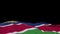 Namibia fabric flag waving on the wind loop. Namib embroidery stiched cloth banner swaying on the breeze. Half-filled black