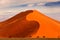 Namibia landscape. Big orange dune with blue sky and clouds, Sossusvlei, Namib desert, Namibia, Southern Africa. Red sand, biggest