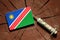 Namibian flag on a stump with syringe injecting money