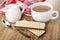 Napkin, pitcher with milk, cup of cocoa with milk, spoon, wafers with porous chocolate on wooden table