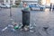 Naples, Italy - August 15, 2019: Overloaded trash can in Naples hitoric city center in summer