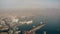 NAPLES, ITALY - DECEMBER 29, 2018. Aerial view of the city seaport area and distant Mount Vesuvius in the haze