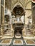 Naples, Italy - September 28, 2023: Part of the baptismal font with Jesus and John the Baptist pointing upwards to the Holy Spirit