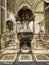 Naples, Italy - September 28, 2023: Part of the baptismal font with Jesus and John the Baptist pointing upwards to the Holy Spirit