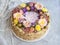 Napoleon cake with vanilla cream, decorated with buttercream flowers - roses, scabioses, chrysanthemums in pink, yellow, purple