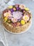 Napoleon cake with vanilla cream, decorated with buttercream flowers - roses, scabioses, chrysanthemums in pink, yellow, purple