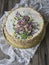 Napoleon cake with vanilla cream, decorated with buttercream flowers. Vintage style. Wooden background, lace napkin. Copy space, c