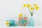 Narcissus or daffodil flowers in vase, coffee cup and gift box for greeting on mother day.