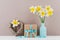 Narcissus or daffodil flowers in vase, wicker heart and gift box for greeting on mother day.