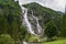 Nardis Waterfall through the green forest in Adamello Brenta Natural Park