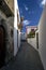 A narrow aisle with multicolored flowers in an old village on Stromboli island