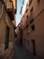 Narrow alley cobblestone streets of charming picturesque city town of Segovia mediterranean rustic architecture in Spain