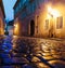 narrow alley with lanterns and pavement stones in Prague street at night