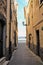 Narrow alley of Marta fishermen burg with landscape of Bolsena lake