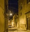Narrow alley in old town Alghero at night