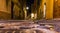 Narrow alley in old town Alghero seen from the ground