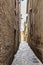 Narrow alleys between vertiginous walls of ancient buildings