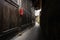 Narrow alleyway between earthen wall and aged Chinese mansion