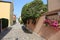 Narrow alleyway of a small Italian country with flowers