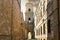 The narrow ancient alley leading to an arched doorway of the bell tower, outside the Duomo cathedral of Brindisi, Italy