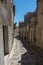 Narrow ancient cobblestone street of medieval town Erice, Sicily