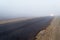 Narrow asphalt road in the fog