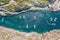 Narrow bay with pleasure boats among the rocks, aerial view