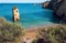 Narrow beach in scenic cliffs and seaside of Portugal. Ocean waves on peaceful and sunny area of Algarve