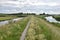 Narrow bicycle lane over wierdijk on former island Wieringen