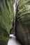 Narrow boardwalk between overhanging rocks