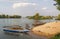 Narrow boats and sunbathers, at small Don Det Island, jetty beach and entry point