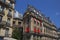 Narrow building with red yellow and blue awnings Paris