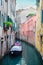 Narrow canal with a boat in Venice