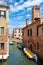 Narrow canal with a small bridge in the romantic city of Venice