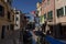 Narrow Canal View with boats in Venice, Italy