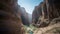 a narrow canyon with a river running through it in the desert