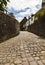Narrow cobbled ally way entry with leading lines