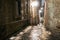 Narrow Cobbled Stairway between Old Stone Buildings at Night