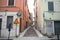 Narrow cobbled street in an italian town seen from its entrance