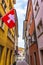 Narrow cobbled street wit Swiss flag Zurich city Old town Switzerland