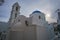 Narrow Cobbled Streets in Tinos island with traditional architectural buildings and local orthodox churches. Tinos, Cyclades