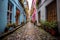 narrow cobblestone alley with colorful doors