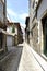 Narrow cobblestone alley with facades of old granite stone houses in the old town called Guimaraes